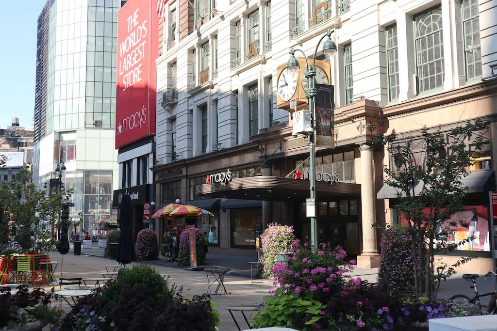 Business professional on phone discussing retail space opportunities with shopping center visible in background, notepad with property details on desk